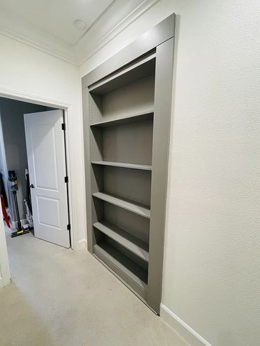 built grey shelving inside the wall