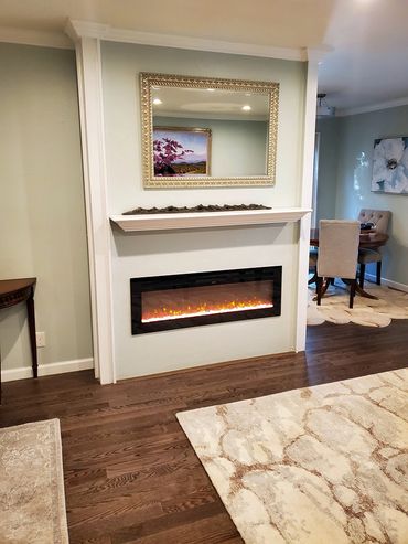 white fireplace, mirror is hanging on top of it