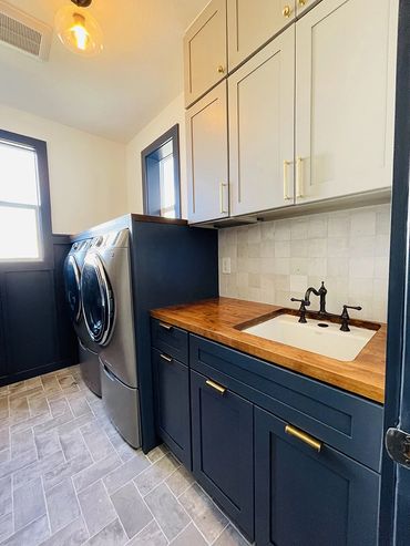 Newly remodeled laundry room, view on the brown counter and white sink