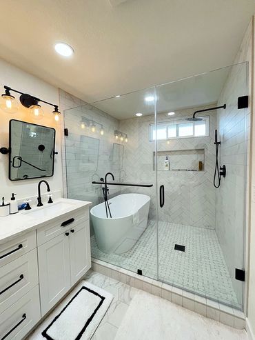 Bathroom remodeled by Top Line Remodeling Inc. White separate tub inside of tiled shower