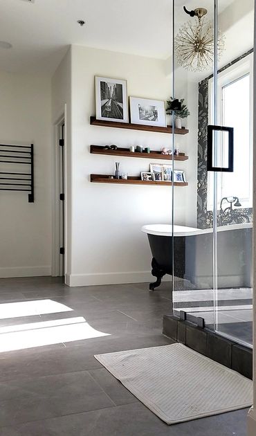 Bathroom remodeled by Top Line Remodeling Inc. Black separate tub, brown wall shelving