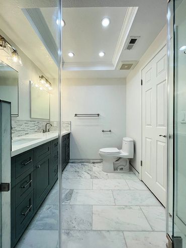 Bathroom remodeled by Top Line Remodeling Inc. Everything is white except black cabinets