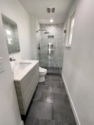 remodeled  bathroom with hanging sink drawer