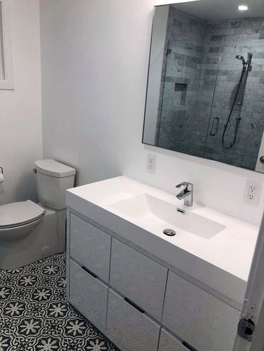 Bathroom renovated by Top Line Remodeling Inc. Tiles with flowers on the floor