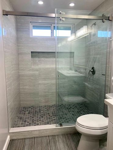 White toilet, grey walk-in shower