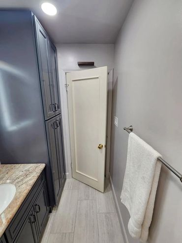 blue cabinets in the remodeled bathroom