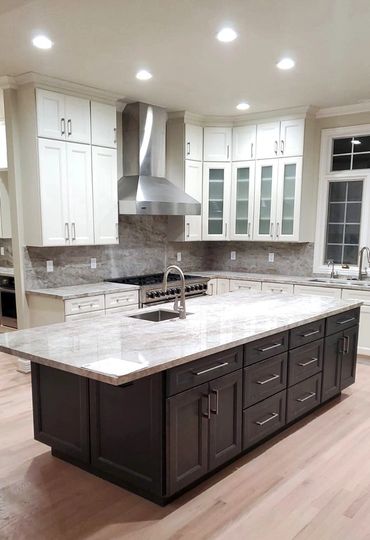 kitchen renovation photo, kitchen island with dark brown cabinets, stove, steel sink