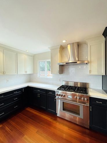 kitchen  photo, black cabinets, stove and fan, small window