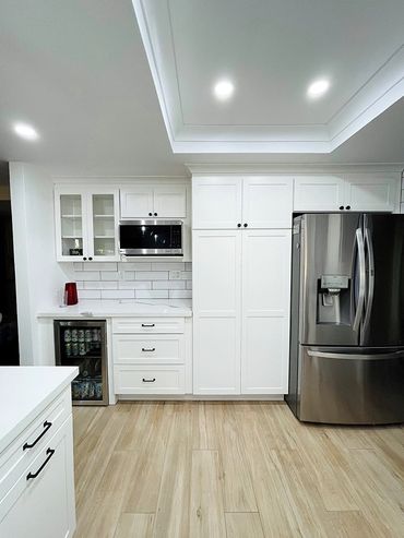 kitchen remodeling photo, white color cabinets, steel refrigerator 