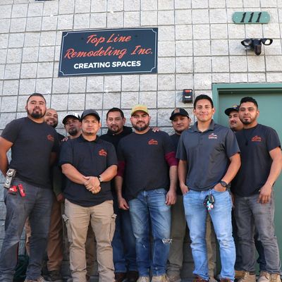 Top Line Remodeling Inc remodeling team is standing under the company's sign