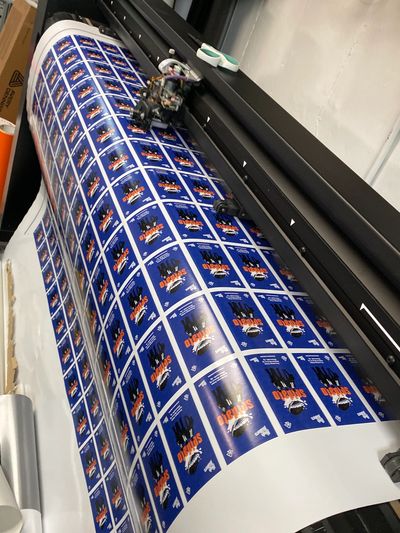 Print-and-cut machine producing custom die-cut vinyl sticker sheets in Brooklyn NYC
