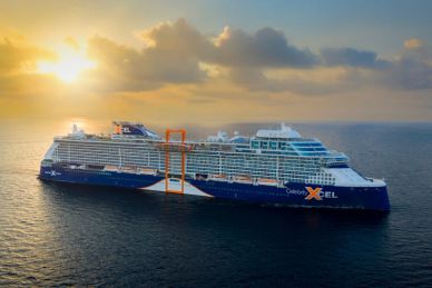 Large cruise ship sailing at sunset.