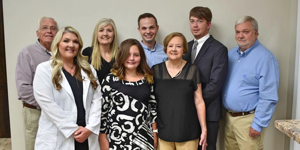 The Ole Town Med family standing next to each other smiling