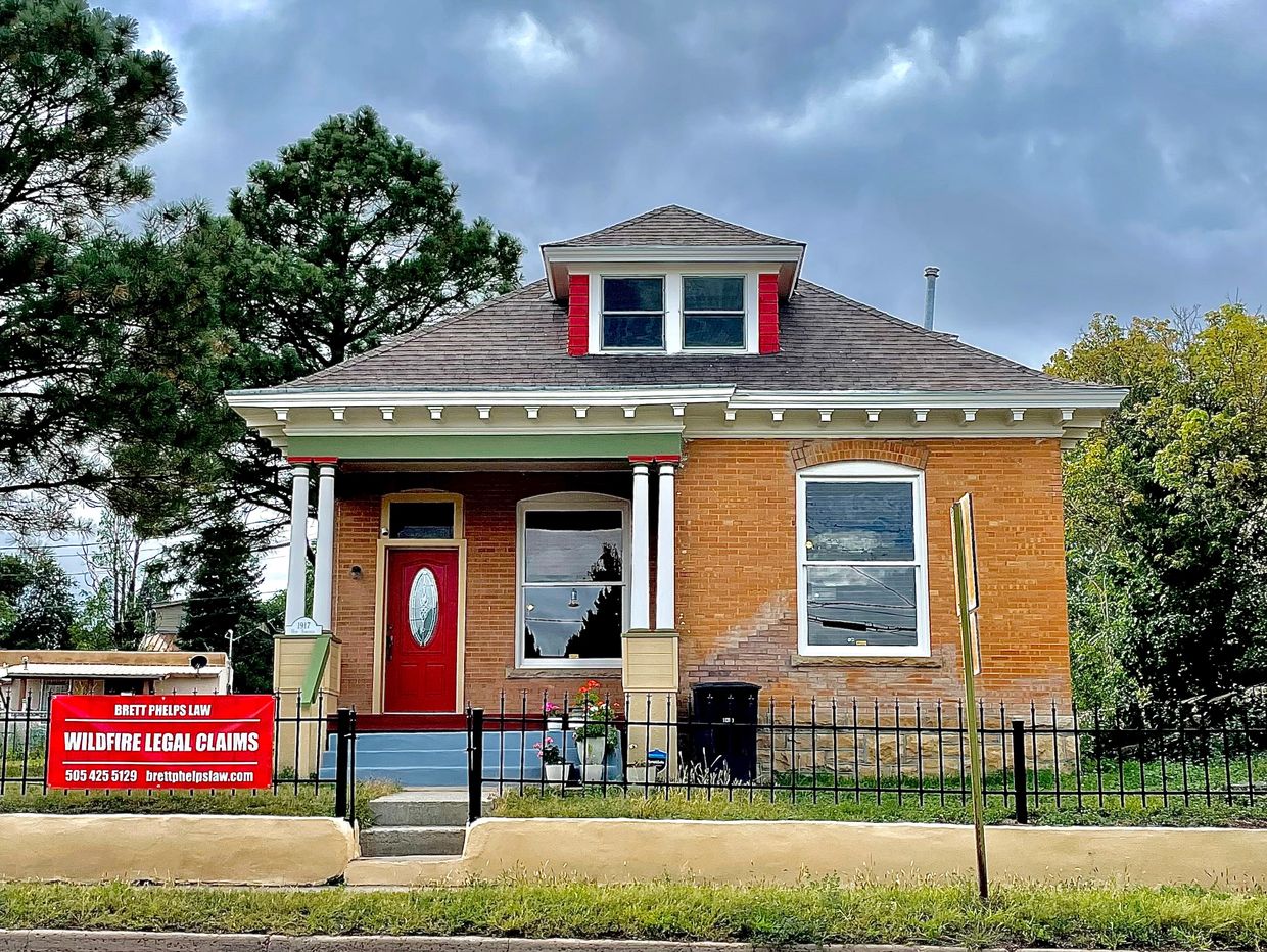 Photo of Brett Phelps office at 1917 Hot Springs Blvd. Two story brick, white pillar porch and color