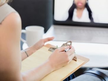 Woman holding a writing pad.