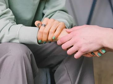Holding hands for support.