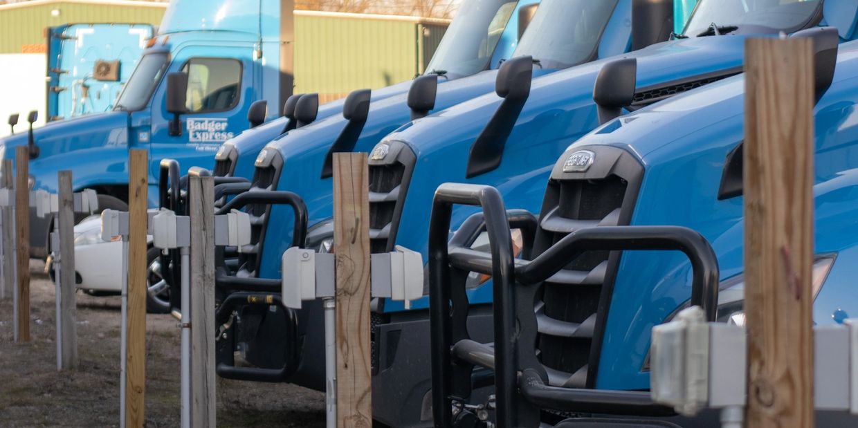 A line of Badger Express's blue trucks lined up outside. 