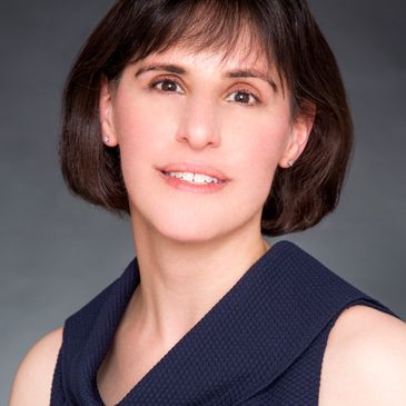 Portrait of a woman with short dark hair and a neutral expression.