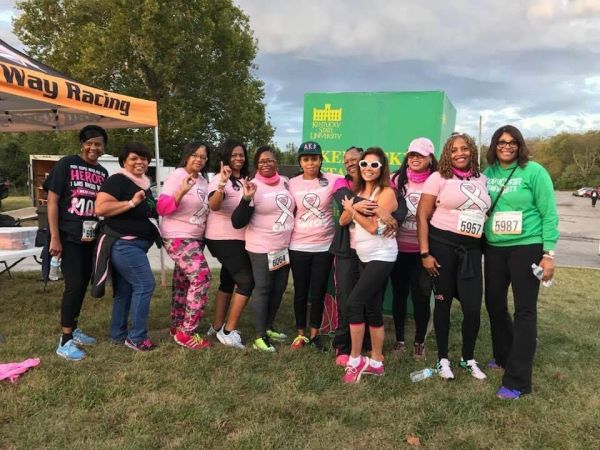 Group of women posing at a cancer awareness event.