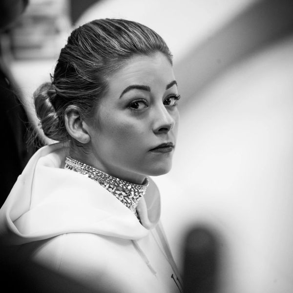 Black and white portrait of a woman with a serious expression.