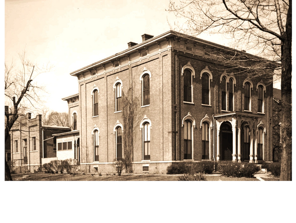 Historic brick building with arched windows and classic architectural details.