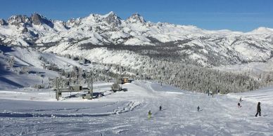 Snowy mountain ski resort with people skiing.