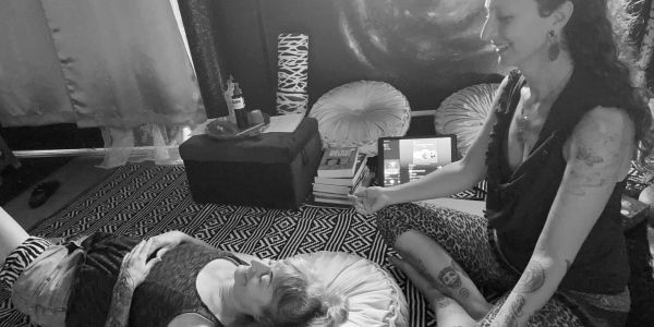 Two women sharing a joyful moment indoors.