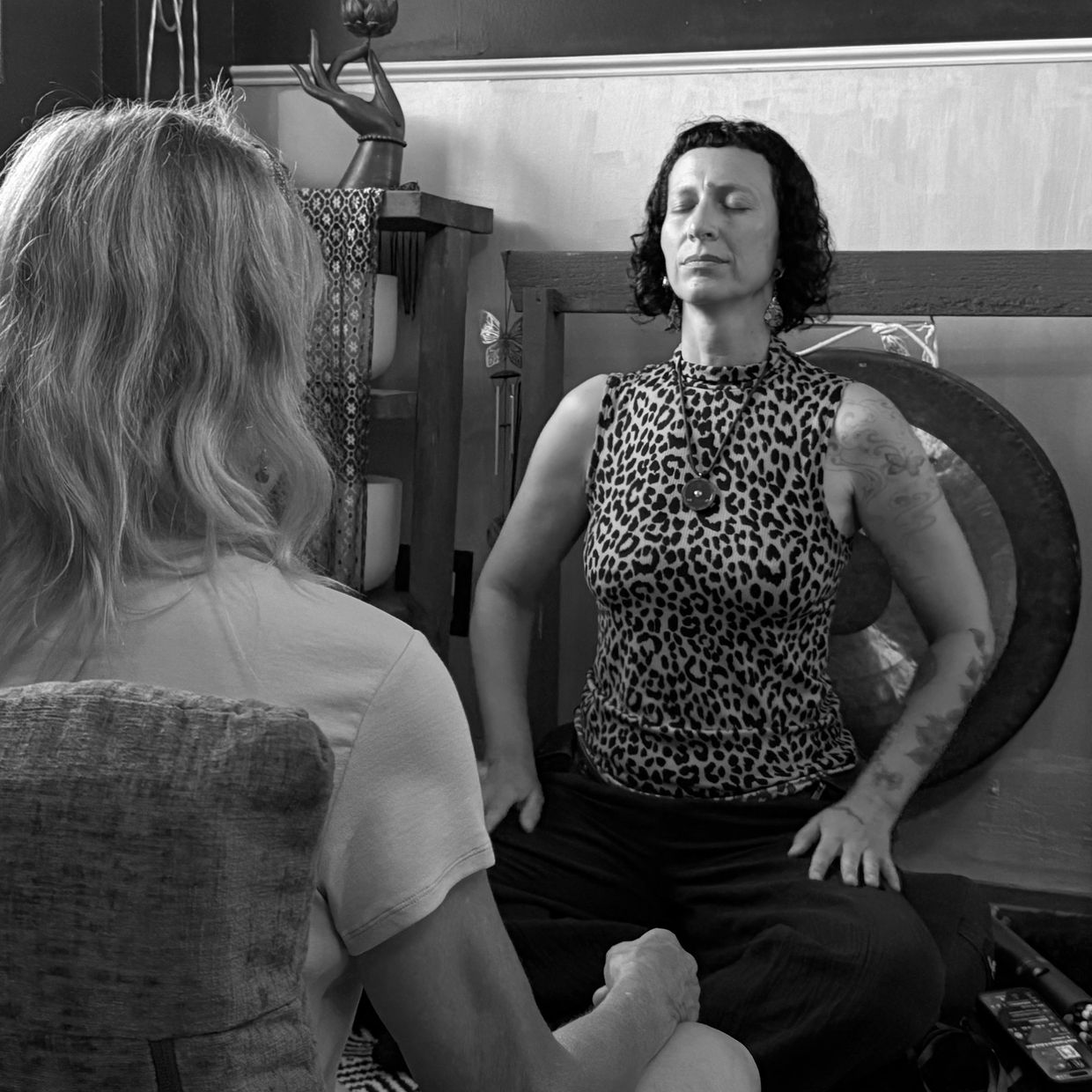 Two women in meditation or therapy session.