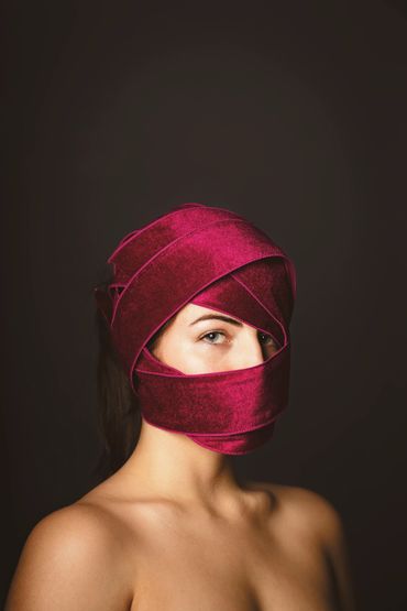 Fine art portrait of beautiful model wrapped in ribbon