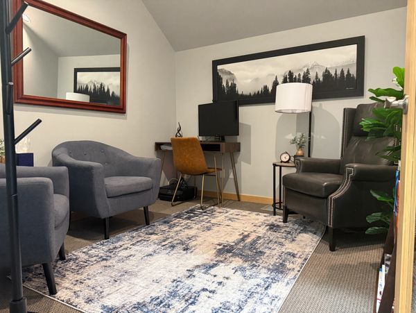 View of office from door, chairs, desk, lamp, mirror, image of mountains