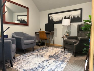 View of office from door, chairs, desk, lamp, mirror, image of mountains