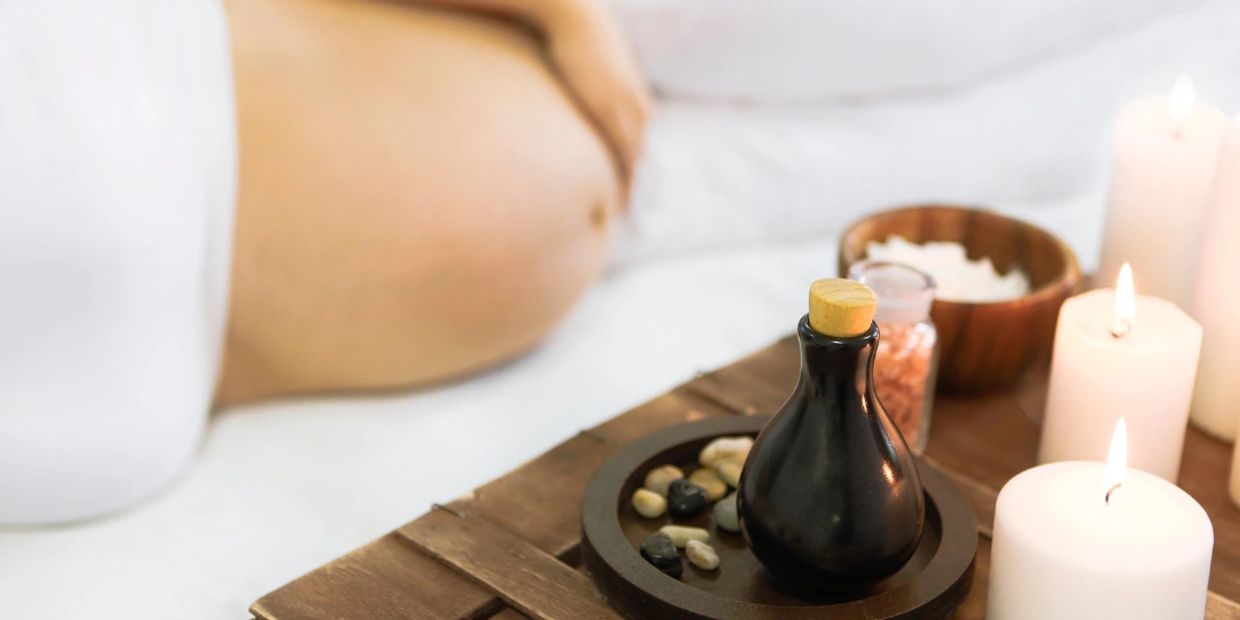 pregnancy massage treatment with oils, crystals and candles