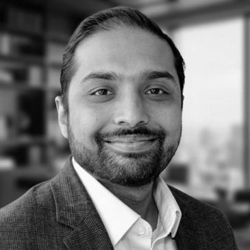Professional man smiling in an office setting.