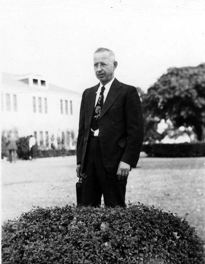 A picture of Victor Houteff standing outside, nicely dressed, in a suit.