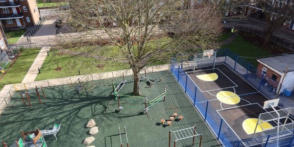 Empty playground and basketball court on a sunny day.