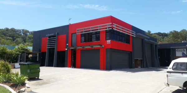 Modern commercial building with red and black exterior.