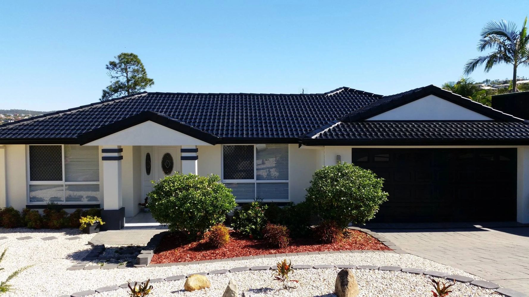 Freshly painted house with finished dark tiled roof
