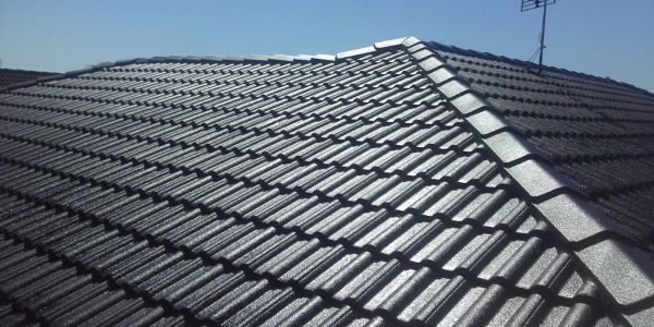 Shiny black tiled roof under sunlight.