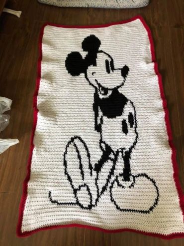 Crocheted blanket with a vintage Mickey Mouse design.