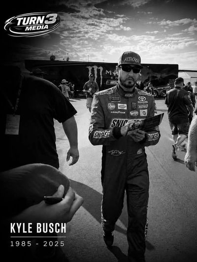 Kyle Busch walking on racetrack with Turn 3 Media logo.