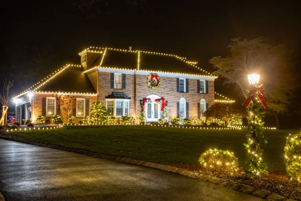 House decorated with Christmas lights and wreaths.