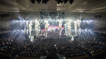 Concert with bright lights and smoke effects.