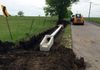 Installing a tin horn (CMP) culvert pipe entrance in Pilot Point, Texas.