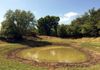 Brush cutting around a small tank in Bowie, Texas.