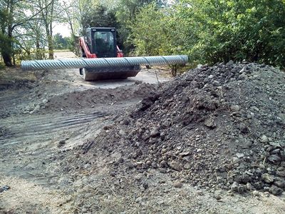 Installing a tin horn (CMP) culvert pipe under a new driveway in Sunset, Texas.