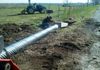 Installing a corrugated metal pipe ( CMP) culvert entrance in Slidell, Texas.