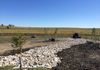 Drainage grading, a dry creek bed and boulder placement in Decatur, Texas.