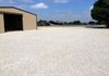 A topping of crushed limestone gravel over new road base for a parking area and gravel driveway in Krum, Texas.
