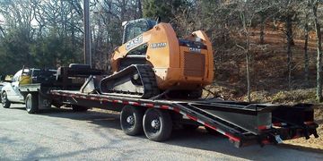 Equipment, skid steer, track loader, attachment hauling Decatur, Texas.