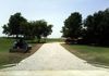 A regraded and repaired gravel driveway using road base in Ponder, Texas.